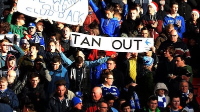 Cardiff's fans express their displeasure with owner Vincent Tan with their signage. Paul Ellis / AFP