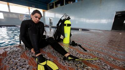 A woman puts on her scuba diving kit for a lesson with coach Elaf, in Basra, Iraq. Reuters