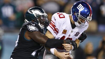 Philadelphia Eagles defensive end Vinny Curry, left, sacks New York Giants quarterback Eli Manning during the first half of an NFL football game, Sunday, Oct. 12, 2014, in Philadelphia. AP Photo/Matt Rourke