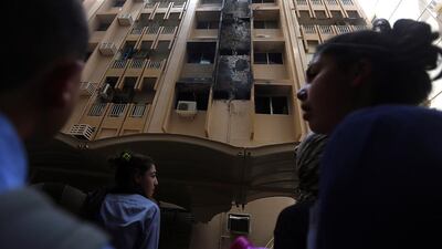 The fire began about 9.45pm in a first-floor flat before spreading to four of 31 other apartments in the King Faisal Street building. Satish Kumar / The National