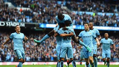 Sergio Aguero of Manchester City is mobbed by teammates after scoring against Manchester United in the Premier League on Sunday at the Etihad Stadium in their 1-0 derby victory. Shaun Botterill / Getty Images / November 2, 2014