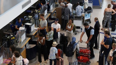 Travellers queue at bag drop for Scandinavian Airlines at Copenhagen Airport in Denmark. Reuters