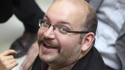 Jason Rezaian, an Iranian-American correspondent for the Washington Post, smiles as he attends a presidential campaign of president Hassan Rouhani in Tehran, Iran. Vahid Salemi / AP Photo