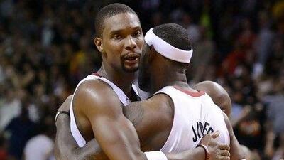 Miami Heat's LeBron James, right, celebrates with Chris Bosh.