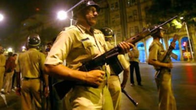 Mumbai police stand guard after shootings took place inside a railway station in Mumbai.