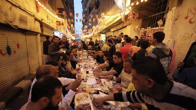 Residents gather in the streets for iftar, in Cairo's Matareya district, during Ramadan last year. EPA