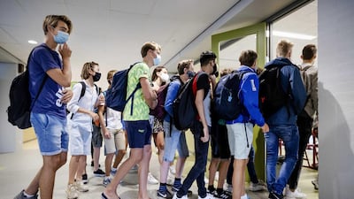 Pupils at Mendel College in Haarlem, Netherlands, pile into class on the first day back on 19 August 2020. Many governments have sought to open schools and offices, as they weigh up the risk of a second wave against the economic and social impact of prolonged closures. EPA