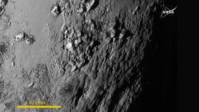 This image released on July 15, 2015 – one of the first ever close-up photos of Pluto – shows a detailed view of a portion of the dwarf planet. AFP Photo/Handout/Nasa TV