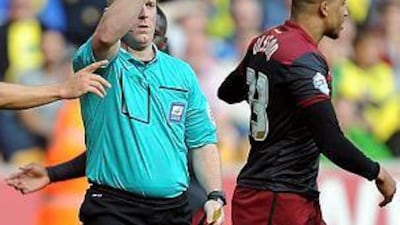 Martin Olsson, right, of Norwich City is shown the red card by referee Simon Hooper during the Championship match between Wolverhampton Wanderers and Norwich City at the Molineux Stadium on August 10, 2014 in Wolverhampton, England. (Photo by Robin Parker/Getty Images)