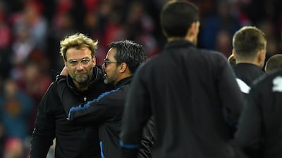 Liverpool manager Jurgen Klopp, left, is embraced by Huddersfield Town counterpart David Wagner following Liverpool's 3-0 triumph at Anfield. Gareth Copley / Getty Images