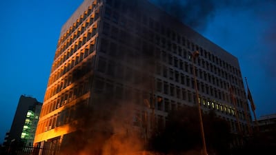 The Lebanese Central Bank is shrouded in black smoke from burning tyres and rubbish bins. EPA