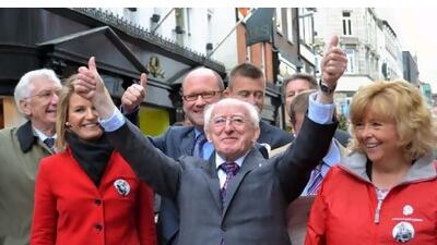 Michael Higgins, centre, campaigning with supporters in Dublin's Henry Street earlier this month.