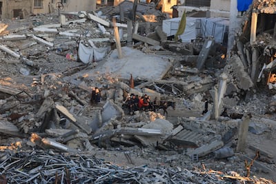Palestinians move past the rubble of residential buildings destroyed during the war, in Gaza city. Reuters