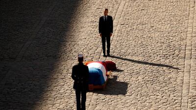French President Emmanuel Macron stands behind the coffin of Charles Aznavour during a ceremony to pay a tribute to late singer Charles Aznavour in Paris. EPAT