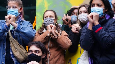 Young climate activists make the sign language symbol for solidarity. PA