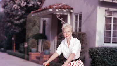 American actor Doris Day poses on a red Schwinn bicycle, late 1950s. Hulton Archive / Getty Images