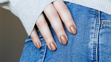 Shorter nails and earthy tones are trending this season. Getty Images