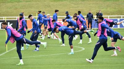 England players stretch during training. PA