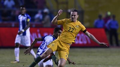 Honduras' Jorge Claros, left, and Australia's Jackson Irvine fall during the first leg of their World Cup qualifying play-off in San Pedro Sula, Honduras. Johan Ordonez / AFP