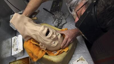 Sculptor Eric Saint Chaffray works on the head of Rolling Stones lead singer Mick Jagger in their workshop. Philippe Wojazer / Reuters