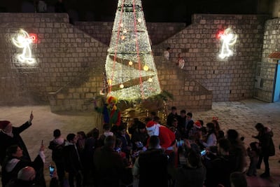 Santa and the large Christmas tree lend festive spirit to the village, and others nearby. AFP
