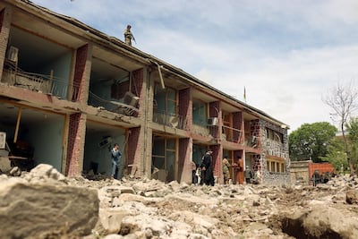 Afghan Army soldiers inspect the scene of a truck bomb blast in Paktia, Afghanistan on May 14, 2020. Militant groups in many countries have stepped up attacks rather than de-escalate during the coronavirus pandemic. EPA