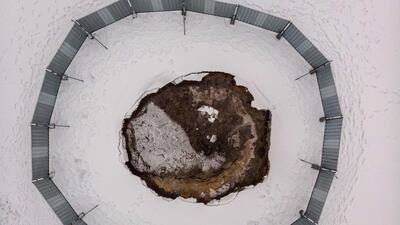 Collapsed ground surrounded by a metal barrier at the local football pitch in Trzebinia, Poland. AFP