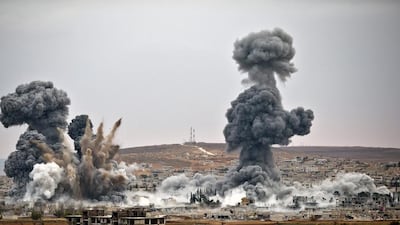 Smoke rises from the Syrian city of Kobani, following airstrikes by the US led coalition on the Turkey-Syria border. Kobani and its surrounding areas have been under assault by ISIL extremists since mid-September and is being defended by Kurdish fighters. Vadim Ghirda / AP Photo