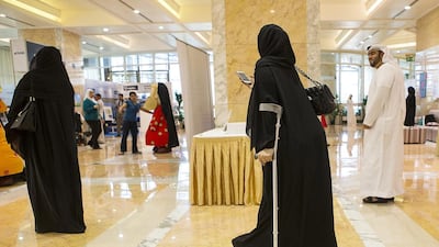 Advocates for those who have special needs, including Salma Al Tamimi, who overcame childhood polio to become a sign language trainer and volunteer at the deaf association in Al Ain, attend a road show on the problems of having disabilites in Abu Dhabi yesterday. Christopher Pike / The National