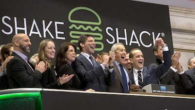 Shake Shack founder Danny Meyer, third right, and Shake Shack chief executive Randy Garutti ring the opening bell at the New York Stock Exchange to celebrate the hamburger chain's initial public offering. Brendan McDermid / Reuters