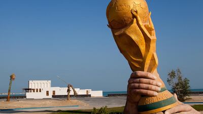 A huge sculpture of the Fifa World Cup trophy is pictured by the sea front in Doha, Qatar. The FIFA World Cup 2022 will take place in Qatar. Nadine Rupp / Getty Images