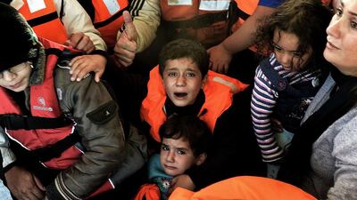 Syrian refugees are rescued by Greek fishermen as their boat sinks off the Greek island of Lesbos (AFP Photo / Aris Messinis)