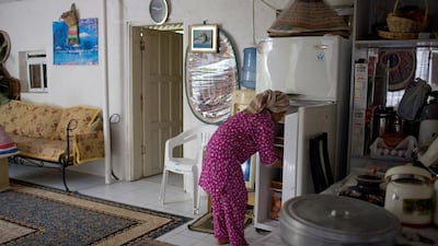 A house maid gathers food from a fridge while preparing lunch. On Wednesday, the Abu Dhabi Judicial Department announced it will be establishing a special prosecution unit dedicated to cases of domestic worker abuse. Philip Cheung / The National