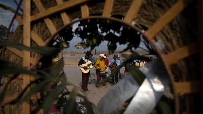 Hired musicians perform as family members attend the burial service of a relative who died from Covid-19 in the Chalco cemetery just outside Mexico City. AP Photo