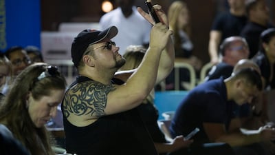 People take photos at the World's Ultimate Deadlift, Burj Plaza, Dubai.