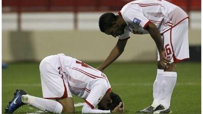 Walid Abbas, left, cannot face his teammates after his own goal against Iraq. Fahad Shadeed / Reuters