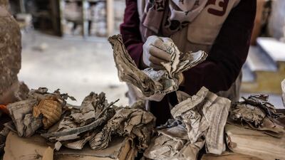 A volunteer in Gaza city restores books and manuscripts destroyed during Israel's war on the enclave. AFP