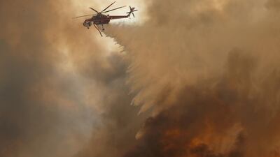 A helicopter drops water in Orange. Mike Blair / Reuters