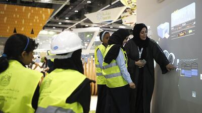School children learn about renewable energy at the Ministry of Climate Change and Environment stall. Ravindranath K / The National
