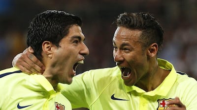 Luis suarez, left, celebrates his second goal with Neymar during Barcelona's 3-1 victory over Paris Saint-Germain. Yoan Valat / EPA