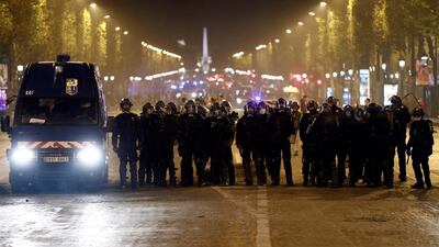 Riot police stand on the Champs-Elysees. EPA