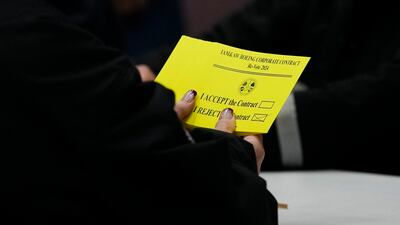 A volunteer holds a vote to reject a new contract offer from Boeing at Seattle Union Hall in Seattle. AP