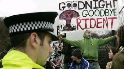 Protesters hold banners up during an anti-Trident missile replacement demonstration at the Faslane Naval base near Glasgow, Scotland.