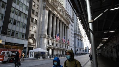 Pedestrians wearing protective masks pass in front of the New York Stock Exchange in the Financial District of New York City, March 5, 2021. Bloomberg