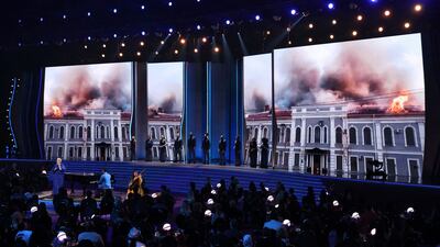 Ukrainian singer Mika Newton performs with John Legend in a tribute to her homeland, ravaged by war with Russia, as images of burning buildings provide a backdrop at the Grammy Awards in Las Vegas. Reuters