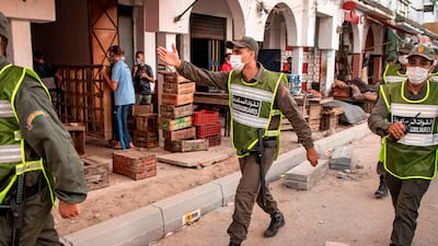 Members of Morocco's Interior Ministry Auxiliary Forces patrol a neighbourhood to enforce the reimposed lockdown due to a spike in coronavirus (COVID-19) cases, in the capital Rabat's district of Takadoum. AFP