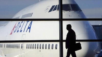 A passenger walks past a Delta Airlines 747 in McNamara Terminal at Detroit Metropolitan Wayne County Airport in Romulus, Michegan. The US and Mexico today removed restrictions for their airlines on routes between the two countryies. Paul Sancya / AP