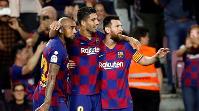 Arturo Vidal, Luis Suarez and Lionel Messi celebrate a goal against Sevilla. EPA