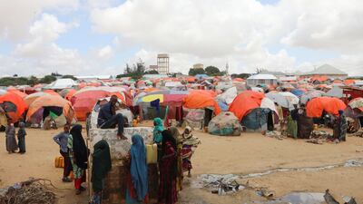People gather to collect water at the Alla Futo camp.