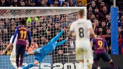 Barcelona's Uruguayan forward Luis Suarez (R) scores his second goal during the Spanish league football match between FC Barcelona and Real Madrid CF at the Camp Nou stadium in Barcelona. AFP